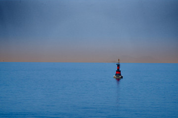 red-black buoy in the evening