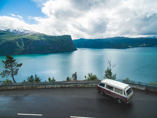 Camper van in front of fantastic panorama mountain and fjord view