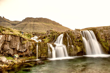 Famous travel location in Iceland. Kirkjufell Waterfalls at sunset, long exposure