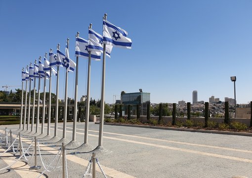 JERUSALEM, ISRAEL. August 13, 2019. A row of flags of Israel in front of the Israeli parliament Knesset. Israeli flags against the sky. Israel Independence Day concept.