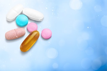 Pills, Capsules and Tablets on abstract bokeh background