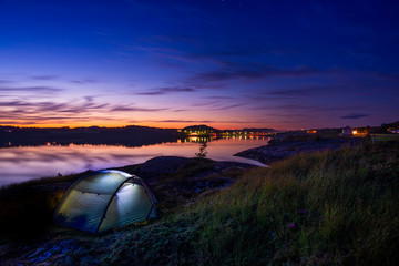 Camping with a tent in the coastal sunset