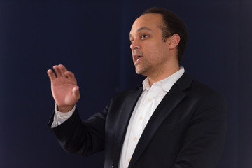 African american business coach gives presentation for business people, multiracial and multiethnic business peoople at conference meeting room.