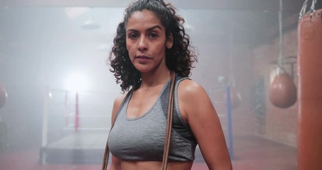 Portrait of strong mixed race female in boxing gym