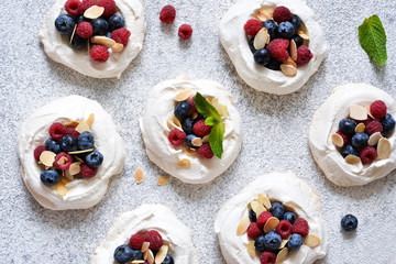 Classic dessert Pavlova with cream and berries. View from above.