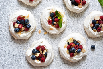 Classic dessert Pavlova with cream and berries. View from above.