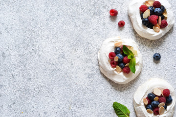 Classic dessert Pavlova with cream and berries. View from above.