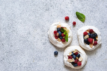 Classic dessert Pavlova with cream and berries. View from above.