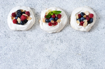 Obraz na płótnie Canvas Classic dessert Pavlova with cream and berries. View from above.