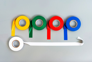 Rubber insulating tape of different colors on a gray background