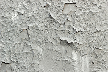 Gray cracked paint on the wall, grunge old wall texture background. Old vintage crack wall.