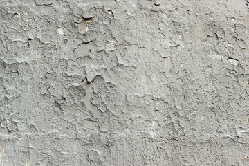 Gray cracked paint on the wall, grunge old wall texture background. Old vintage crack wall.