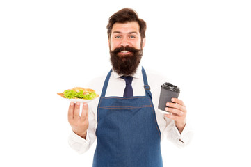 Enjoy your meal. Guy serving croissant stuffed lettuce and fresh vegetables. Healthy food. Delicious croissant. Man bearded waiter wear apron carry plate with food and coffee cup. Cafe food concept