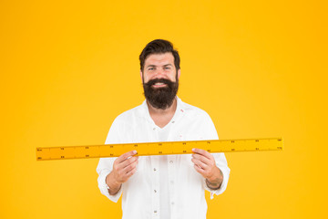 Size tall and length. Big size. Measure and control. Geometry theorem. Actual size. School teacher. Small little big large. Does size really matter. Man bearded hipster holding ruler. Measure length