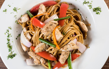Tallarin saltado traditional peruvian meal. On a white plate