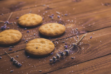 Composition with tasty lavender cookies on wooden table