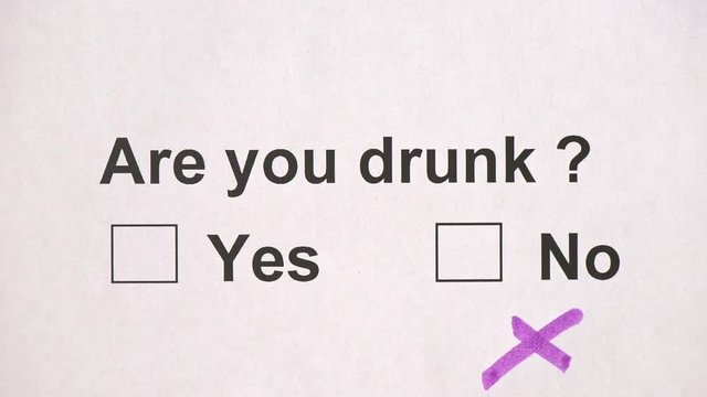 Overhead shot of a caucasian man answering to the question: Are you drunk? on the white piece of sheets