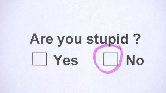 Overhead shot of a caucasian man answering to the question: Are you stupid? on the white piece of sheets