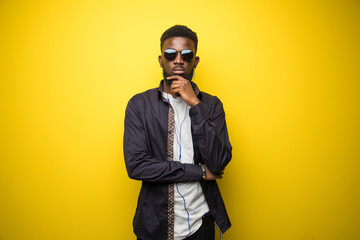 Trendy modern Black man isolated on yellow background