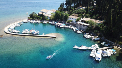 Aerial drone photo of iconic small port and fishing village of Kouloura with turquoise and emerald clear waters, Corfu island, Ionian, Greece