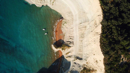 Aerial drone bird's eye view photo of iconic white rock volcanic tropical islet with emerald clear water sea