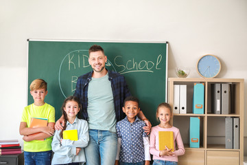 Cute children with teacher in classroom