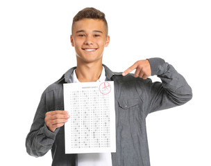Happy boy with results of school test on white background
