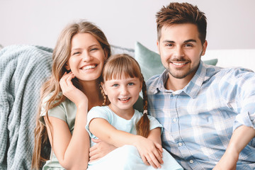 Portrait of happy young family at home