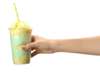 Female hand with tasty cotton candy on white background