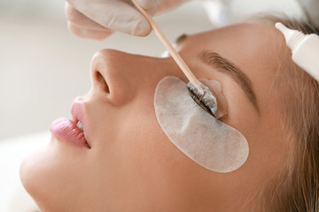 Young woman undergoing procedure of eyelashes lamination in beauty salon, closeup - obrazy, fototapety, plakaty