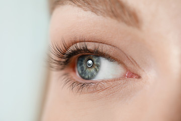 Beautiful young woman after eyelashes lamination and dyeing, closeup