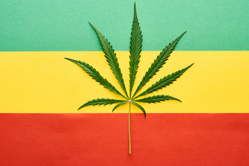 top view of cannabis leaf on Rastafarian flag background