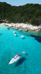 Aerial drone photo of tropical paradise turquoise beach of Voutoumi with sail boats docked in island of Anti paxos, Ionian, Greece - obrazy, fototapety, plakaty
