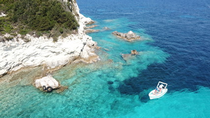 Aerial drone photo of tropical paradise turquoise beach of Voutoumi with sail boats docked in island of Antipaxos, Ionian, Greece