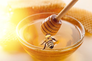 Honey and  wooden spoon  on background