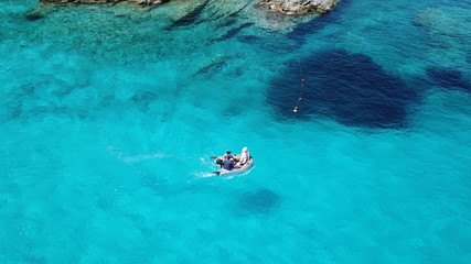 Fototapeta na wymiar Aerial drone photo of beautiful exotic paradise turquoise sandy beach of Voutoumi with sail boats docked in island of Anti paxos, Ionian, Greece