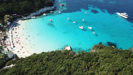Obraz na płótnie Canvas Aerial drone photo of beautiful exotic paradise turquoise sandy beach of Voutoumi with sail boats docked in island of Anti paxos, Ionian, Greece