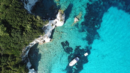 Fototapeta na wymiar Aerial drone photo of beautiful exotic paradise turquoise sandy beach of Voutoumi with sail boats docked in island of Anti paxos, Ionian, Greece