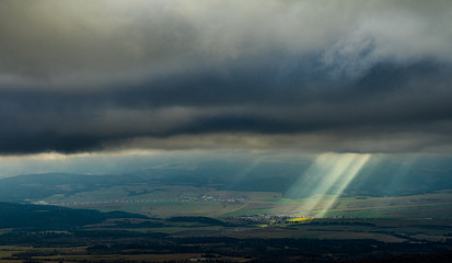Mountains view, sun rays goues from the cloudy ski.