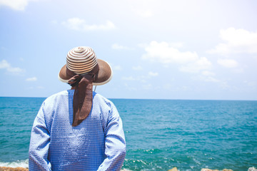 Elderly women travel to the sea to relax. Standing facing the sea