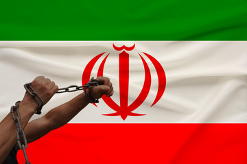 muscular male hands wrapped in a thick iron czar against the background of the state flag, the...