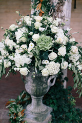 White rose, peony, and hydrangeas in concrete planter, wedding reception flower decor