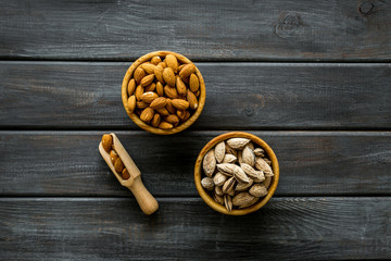 Healthy snack with almonds on wooden background top view