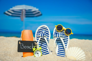 beautiful slippers in the sand of the sea in Greece background