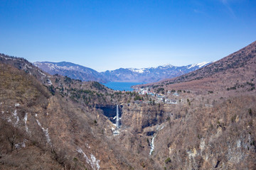 High angle view of lake Chuzenji, Kegon falls and mountain range at the Akechidaira observatory deck.