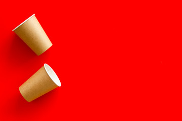 Paper cups for coffee to go on red background top view mockup