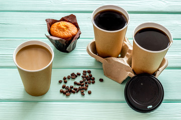 Coffee to go on mint green wooden background