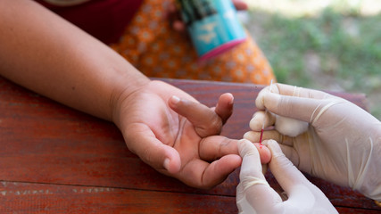 Medical worker or health worker keep blood, finger prick sample of Acetylcholinesterase activity in RBC or Plasma from farmer
