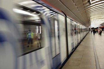a lot of rolling stock departs from the metro station, blurred motion. Subway passengers.