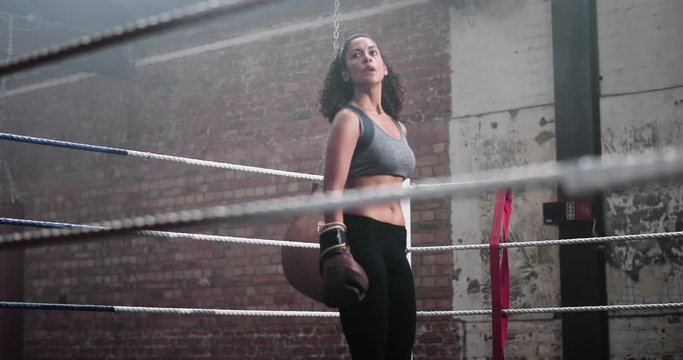 Female boxer stepping into the ring